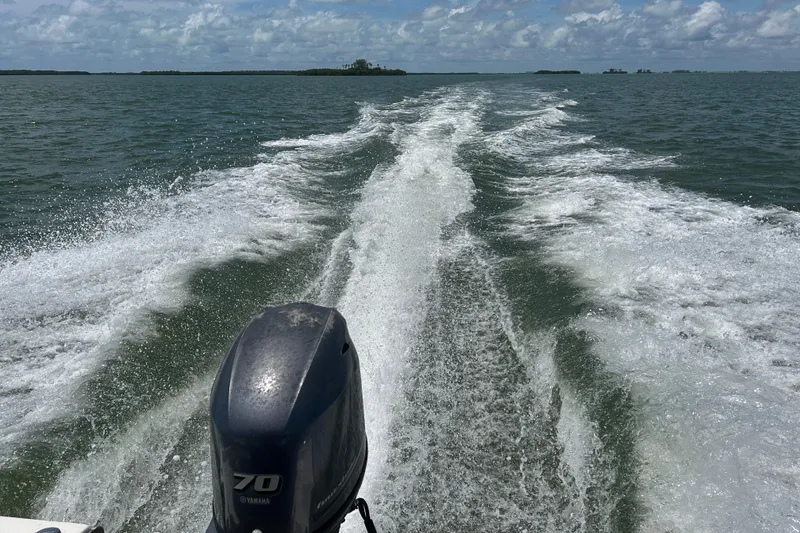 Slide: The Image of Wake trail behind 2016 Key West 1520 Center Console boat on open water. - 20