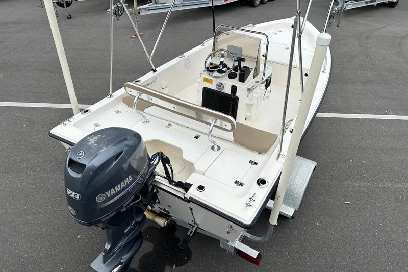 Slide: The Image of 2016 Key West 1520 Center Console boat with Yamaha engine, parked on asphalt. - 7
