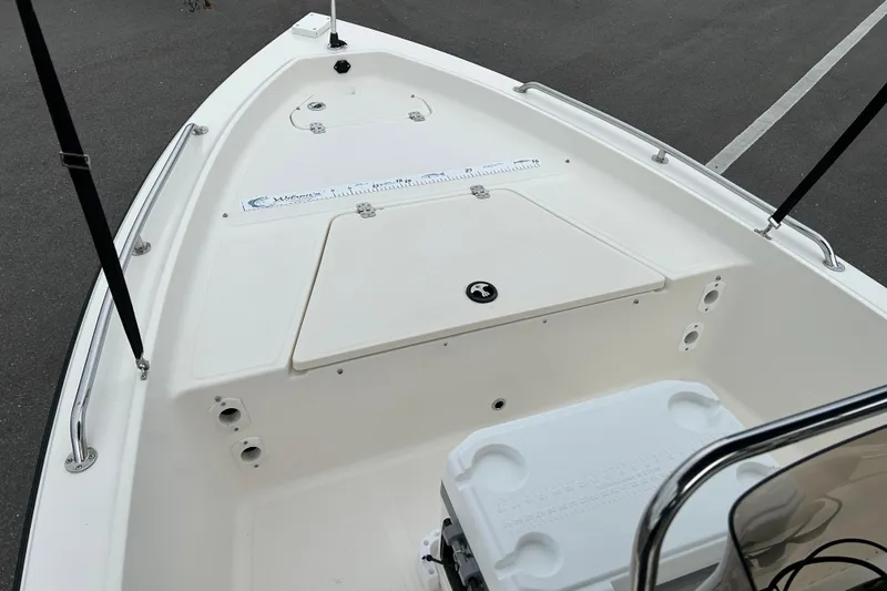 Slide: The Image of 2016 Key West 1520 Center Console boat interior with storage compartments and measuring ruler. - 8