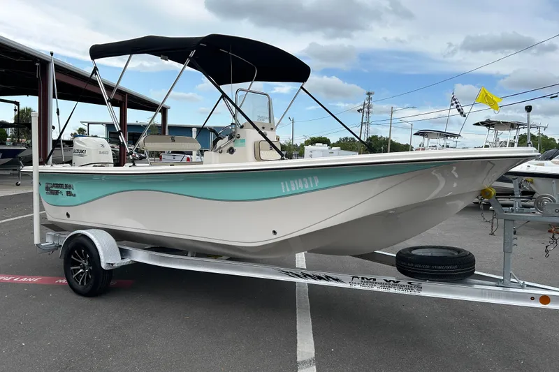 The Image of 2020 Carolina Skiff 19 LS boat on trailer with canopy, parked outdoors. - 1