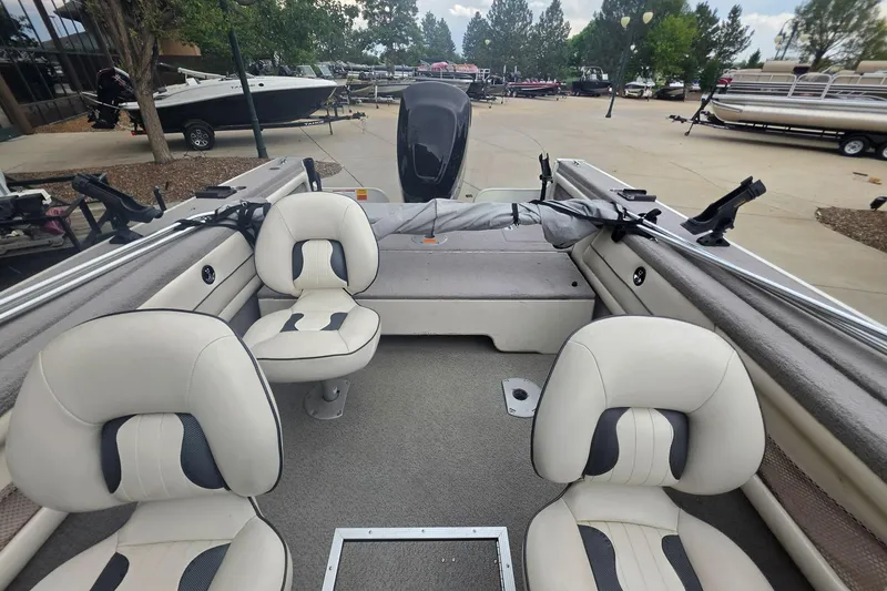 Slide: The Image of Interior of a 2010 Starcraft NexStar 1910 I/O boat with seating and fishing rod holders. - 2