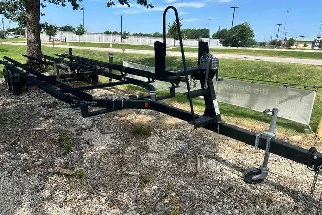 Slide: The Image of Trailer for 2021 Bennington L Bowrider 25 Quad Bench, parked on gravel near trees. - 26