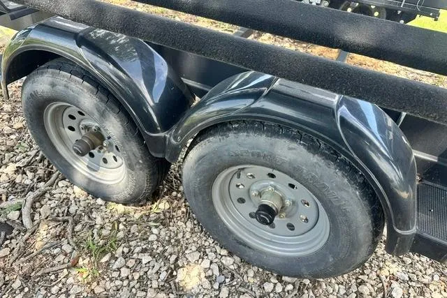 Slide: The Image of Trailer wheels for 2021 Bennington L Bowrider 25 Quad Bench on gravel. - 29