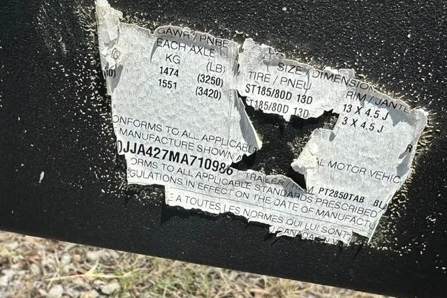 Slide: The Image of Torn label on a 2021 Bennington L Bowrider 25 Quad Bench, showing weight and tire specifications. - 31