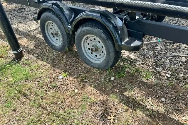 Slide: The Image of Trailer with flat tire for 2021 Bennington L Bowrider 25 Quad Bench boat. - 32