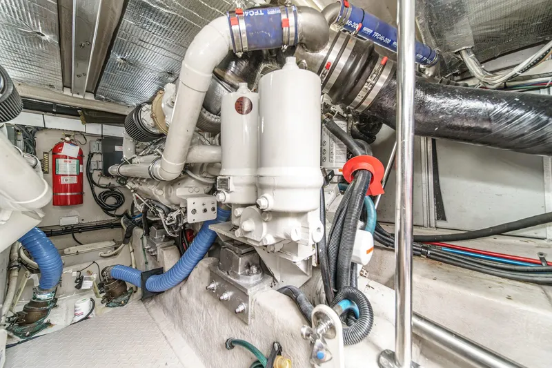 Slide: The Image of Engine room of 2008 Sea Ray 58 Sedan Bridge yacht, featuring complex machinery and piping. - 22