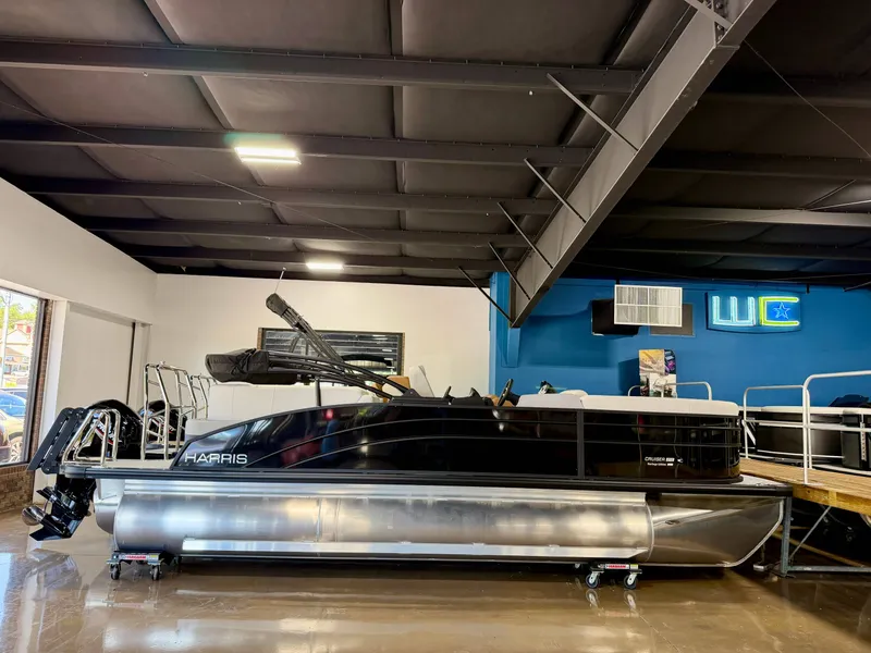 The Image of A 2026 Harris Cruiser 210 Heritage is displayed in a showroom. - 1
