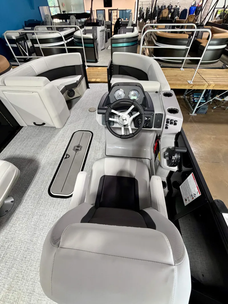 Slide: The Image of Interior view of a Harris Cruiser 210 Heritage with gray seating and a modern helm station. - 10