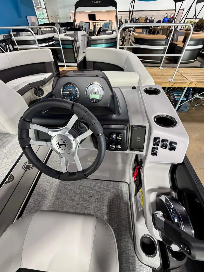 Slide: The Image of Interior view of a Harris Cruiser 210 Heritage with modern helm and sleek seating. - 11