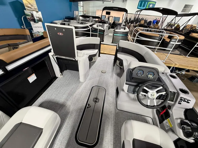 Slide: The Image of Interior view of a Harris Cruiser 210 Heritage pontoon boat with gray seating and a helm station. - 12
