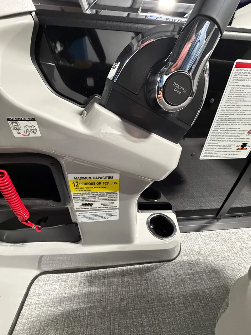 Slide: The Image of Close-up of a Harris Cruiser 210 Heritage helm with cup holder and safety labels. - 15