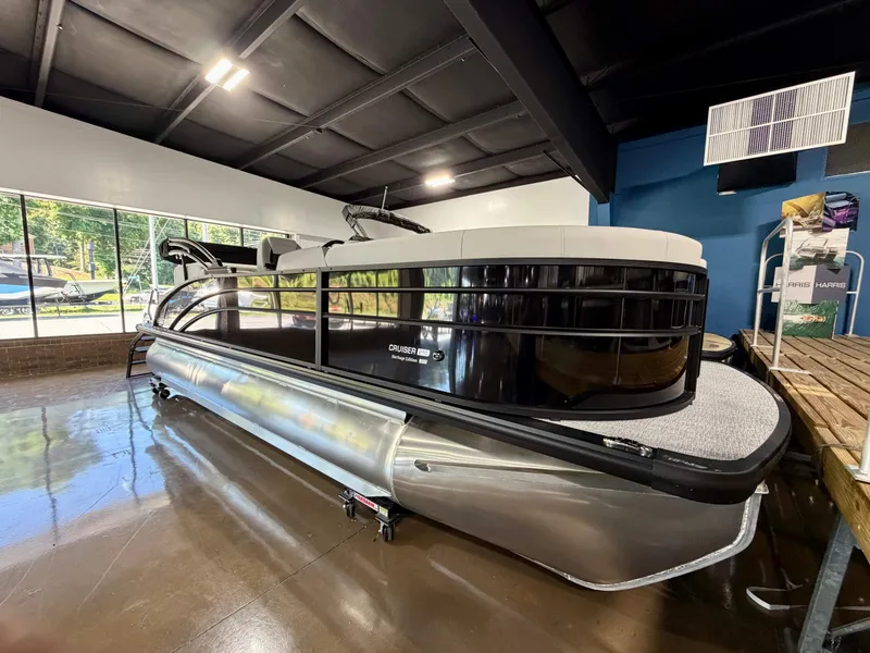Slide: The Image of A sleek pontoon boat is displayed in a showroom. It features a modern design and shiny surfaces. - 2