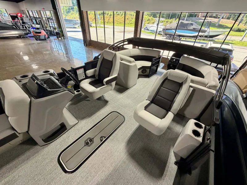 Slide: The Image of Interior of a Harris Cruiser 210 Heritage with gray and black seating, steering wheel, and control console. - 9