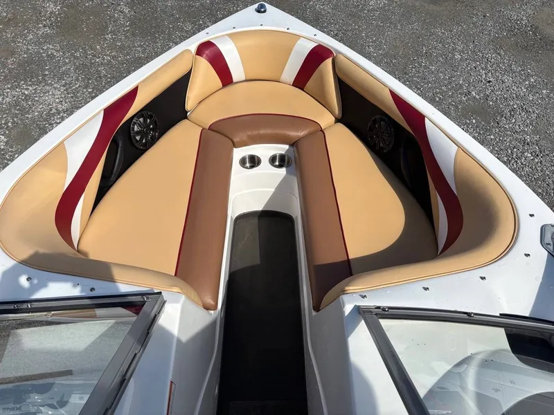 Slide: The Image of The image shows the bow of a 2006 Moomba Mobius LSV with beige and red seating. - 10