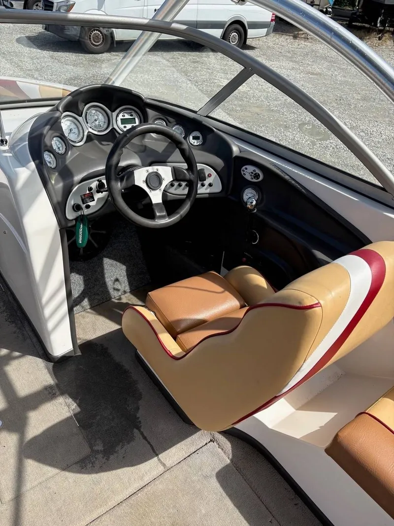Slide: The Image of The image shows the cockpit of a 2006 Moomba Mobius LSV with a black steering wheel and beige seats. - 14