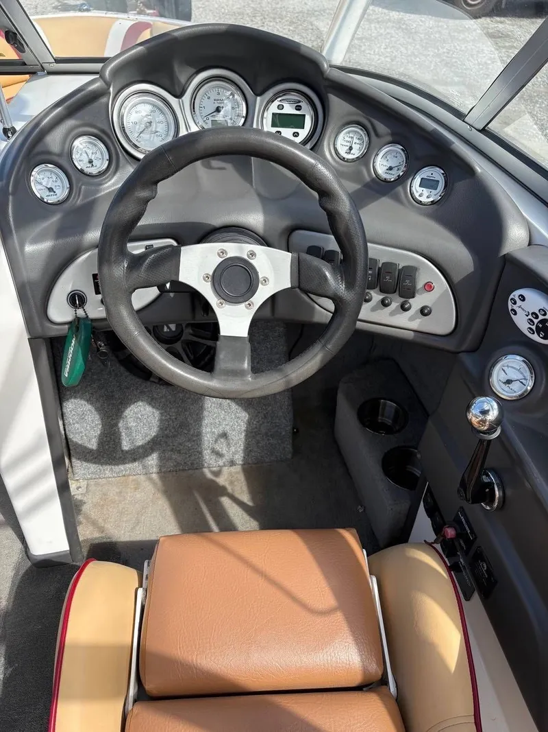 Slide: The Image of The image shows the cockpit of a 2006 Moomba Mobius LSV with a black steering wheel and multiple gauges. - 16