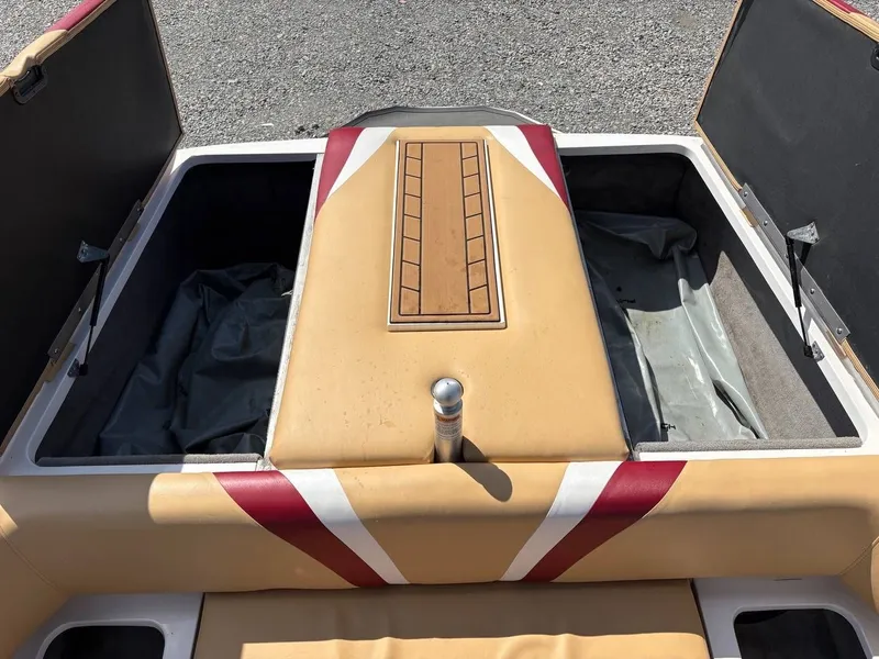 Slide: The Image of The image shows the rear storage area of a 2006 Moomba Mobius LSV with beige upholstery. - 6
