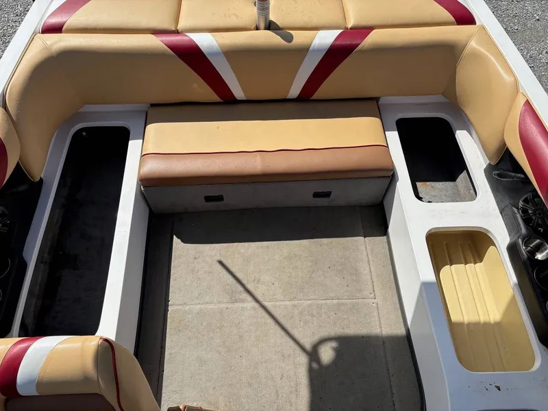 Slide: The Image of Interior of a 2006 Moomba Mobius LSV with beige and red seating. - 7