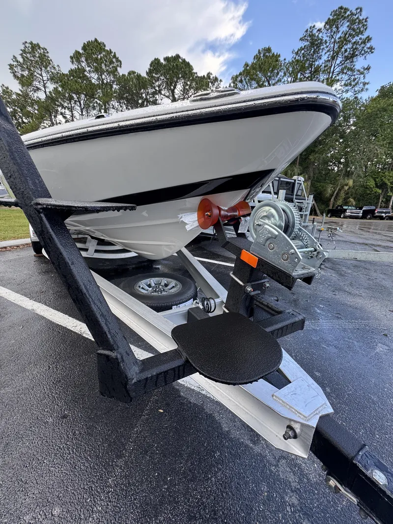 Slide: The Image of A Skeeter SX Series SX241 boat on a trailer, parked on an asphalt lot. - 11