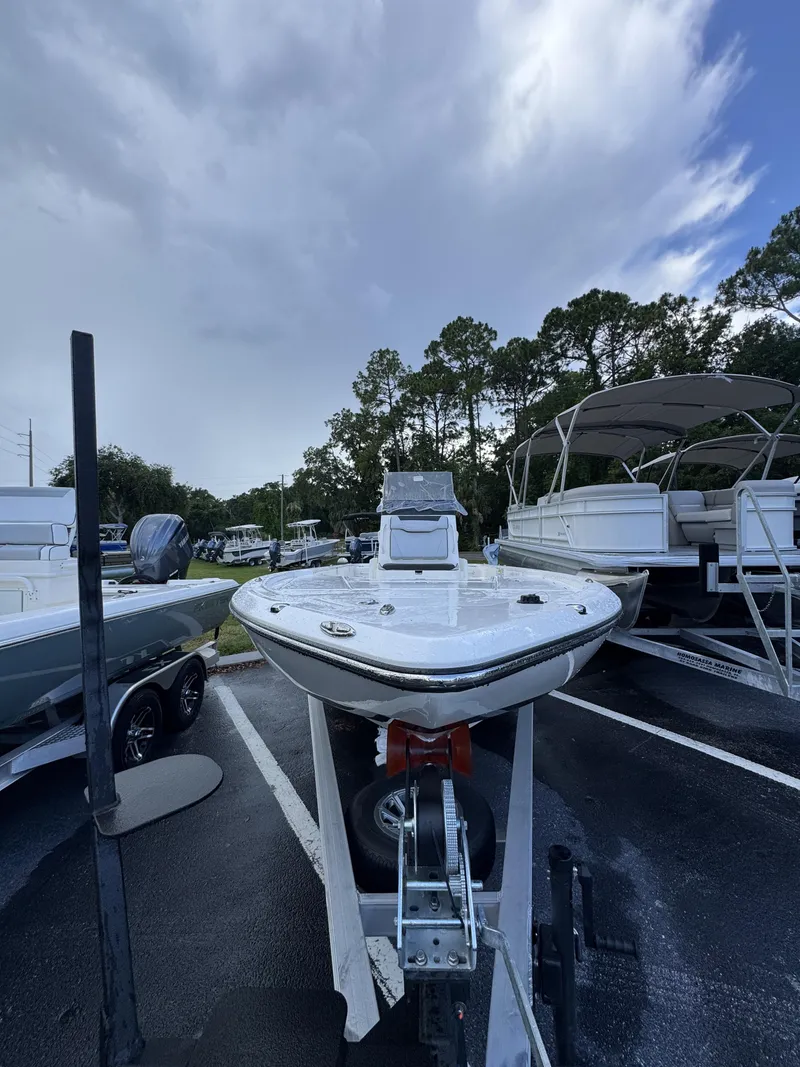 Slide: The Image of A Skeeter SX Series SX241 boat on a trailer, surrounded by other boats in a parking lot. - 12