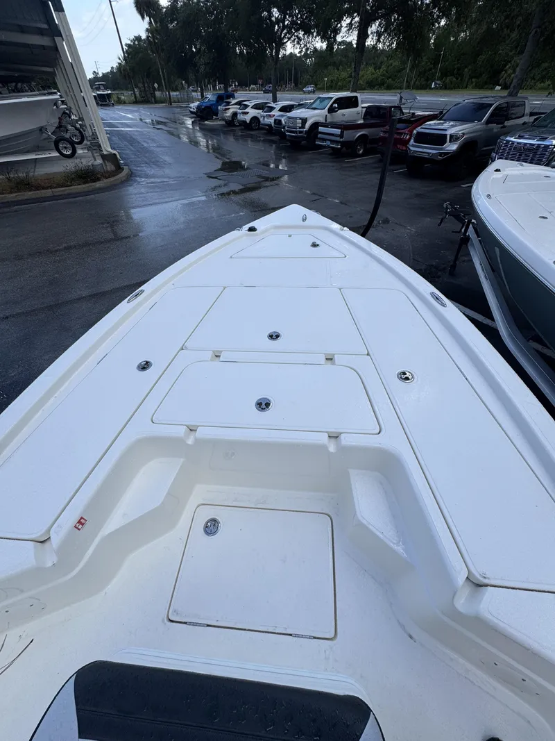 Slide: The Image of The image shows the deck of a white boat with multiple storage compartments. - 13
