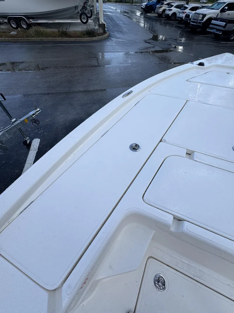 Slide: The Image of The image shows the deck of a white boat with several storage compartments. - 14