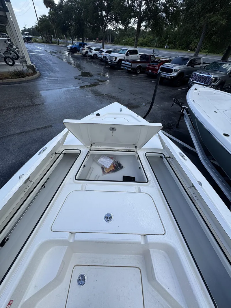 Slide: The Image of Skeeter SX Series SX241 2026: Spacious deck with storage compartments, parked in a lot. - 15