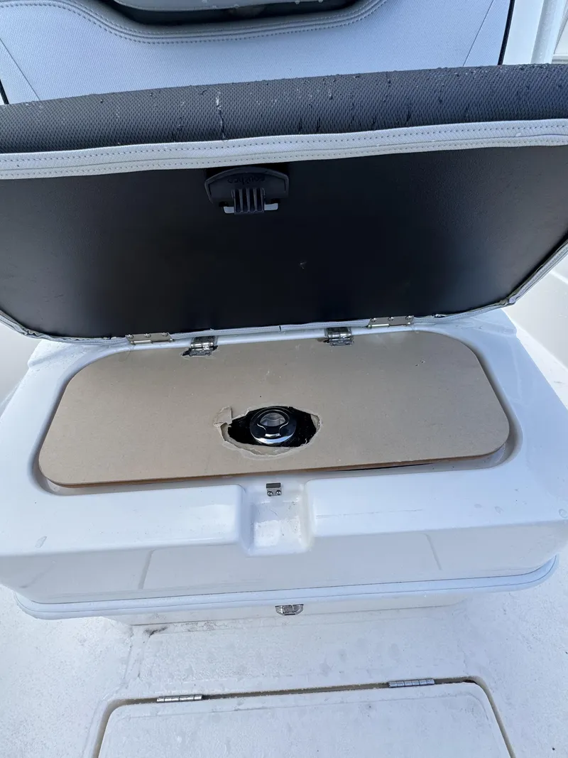 Slide: The Image of Open storage compartment with a cushioned lid on a boat. - 17
