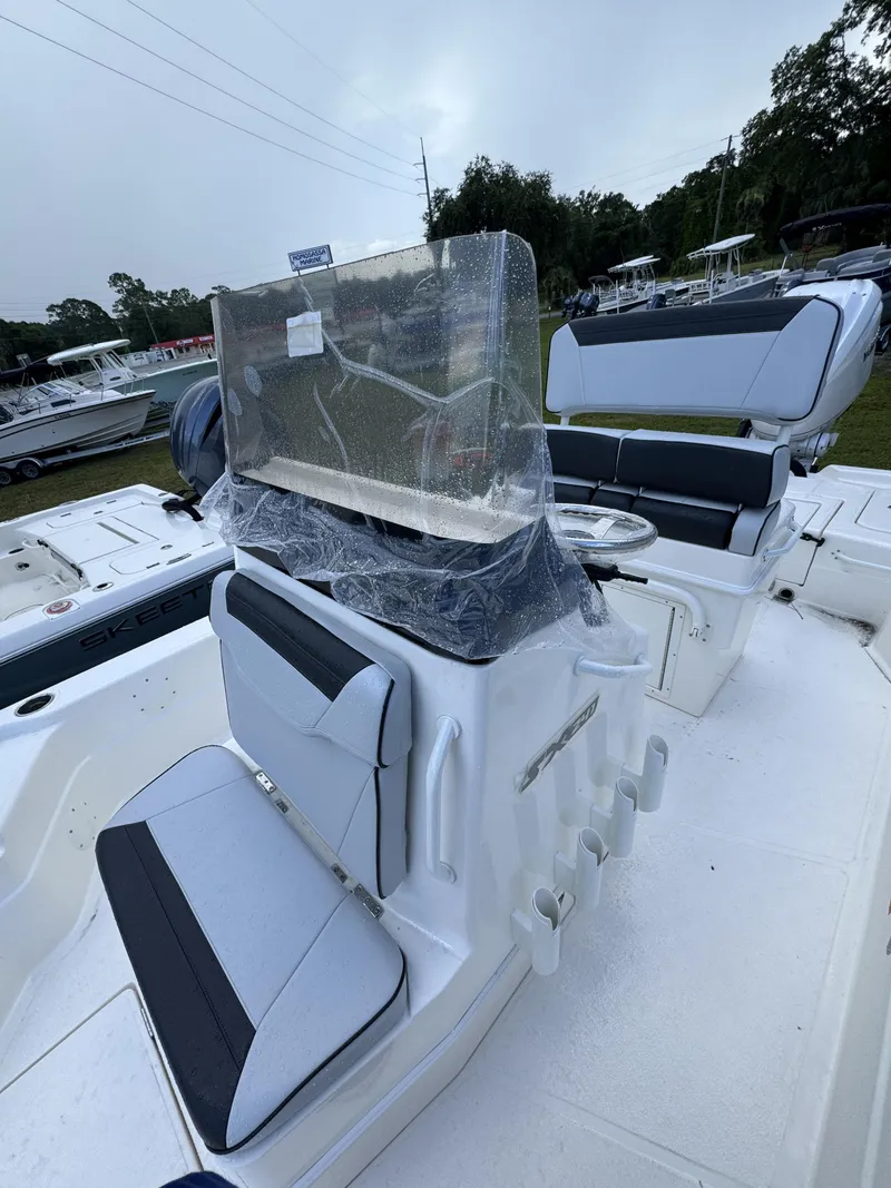 Slide: The Image of The image shows the cockpit of a Skeeter SX Series SX241 boat with gray and black seating. - 22