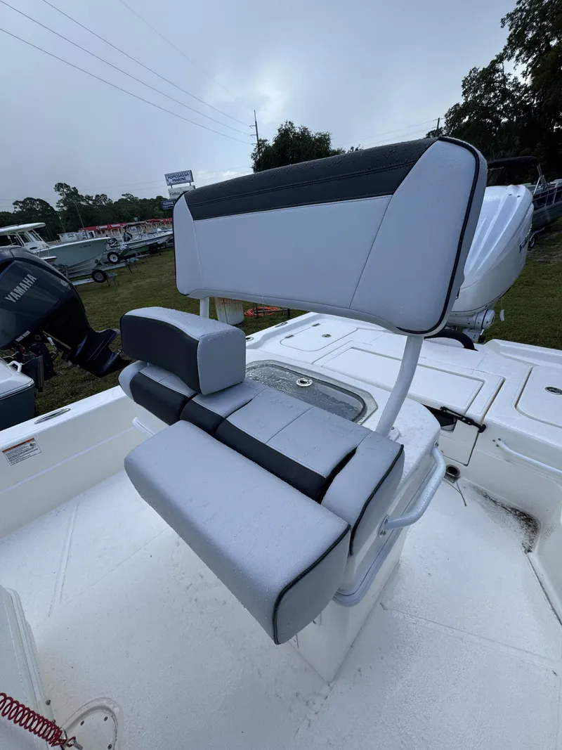 Slide: The Image of The image shows a boat's seating with gray and black upholstery. - 23