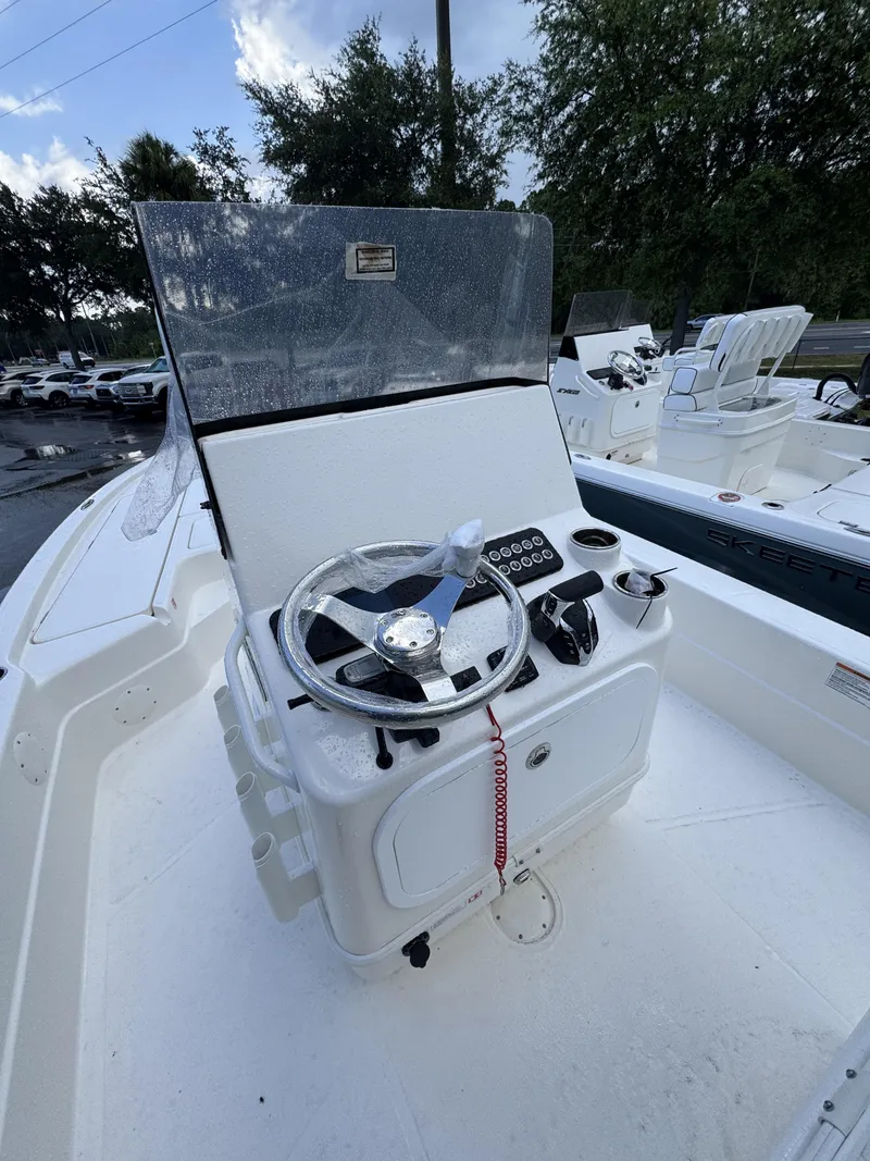 Slide: The Image of The image shows the helm of a white boat with a steering wheel and instruments. - 26