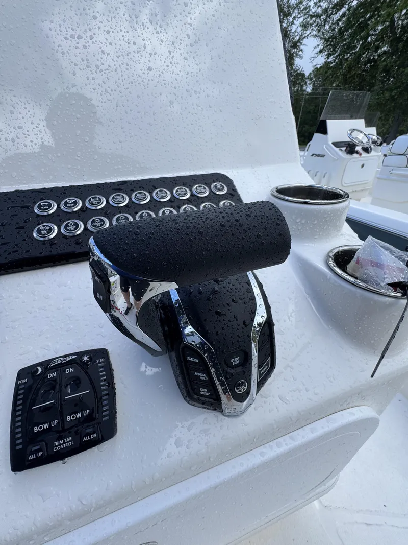 Slide: The Image of Close-up of a boat's helm with modern controls and cup holders. - 27