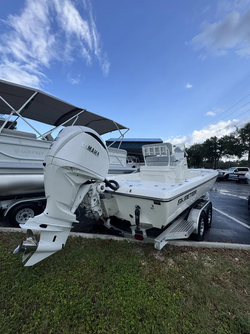 Slide: The Image of A white Skeeter SX Series SX241 boat on a trailer. It features a Yamaha outboard motor. - 3
