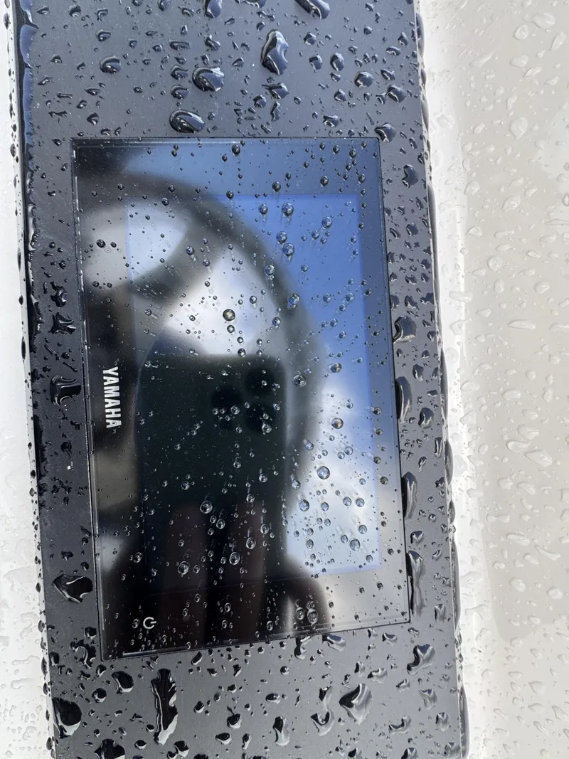 Slide: The Image of A wet Yamaha display on a boat with raindrops. - 30
