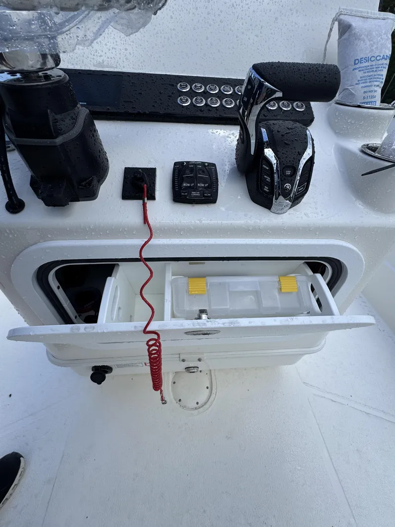 Slide: The Image of The image shows a boat's cockpit with controls and an open storage compartment. - 31
