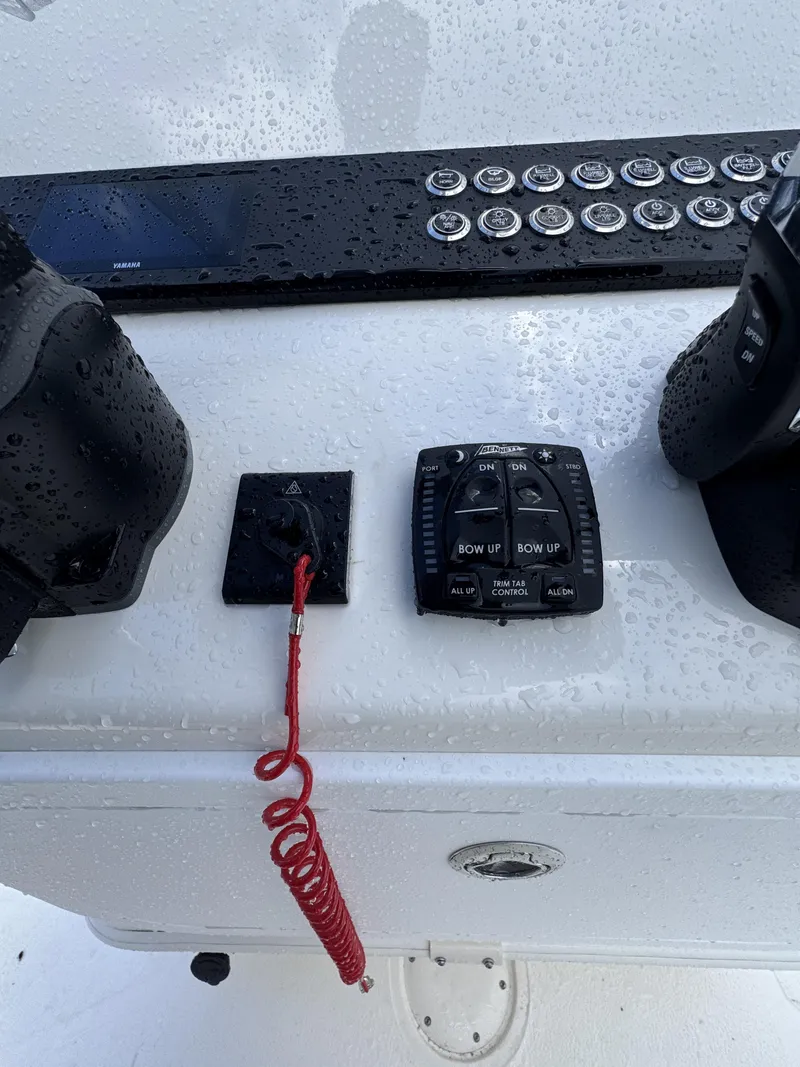 Slide: The Image of Close-up of a boat console with control buttons and a safety lanyard. - 34