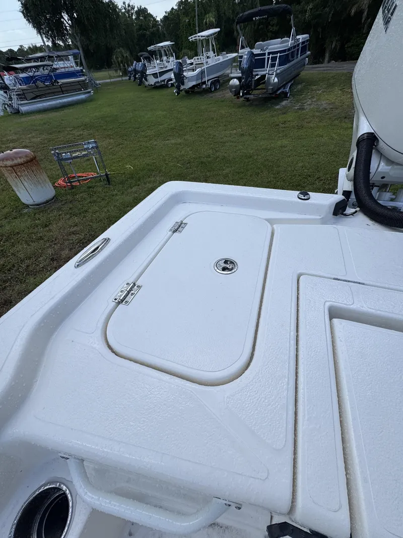 Slide: The Image of The image shows the deck of a Skeeter SX Series SX241 boat, positioned on grass. - 41