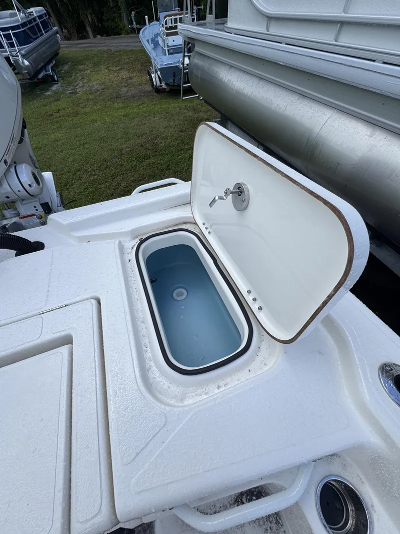 Slide: The Image of An open storage compartment on a boat with a faucet and blue interior. - 42