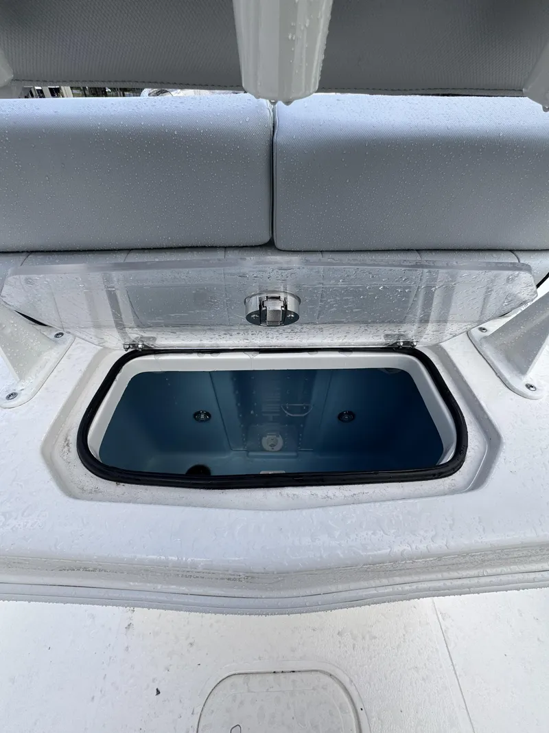 Slide: The Image of An open storage compartment on a boat with gray upholstery and a blue interior. - 43
