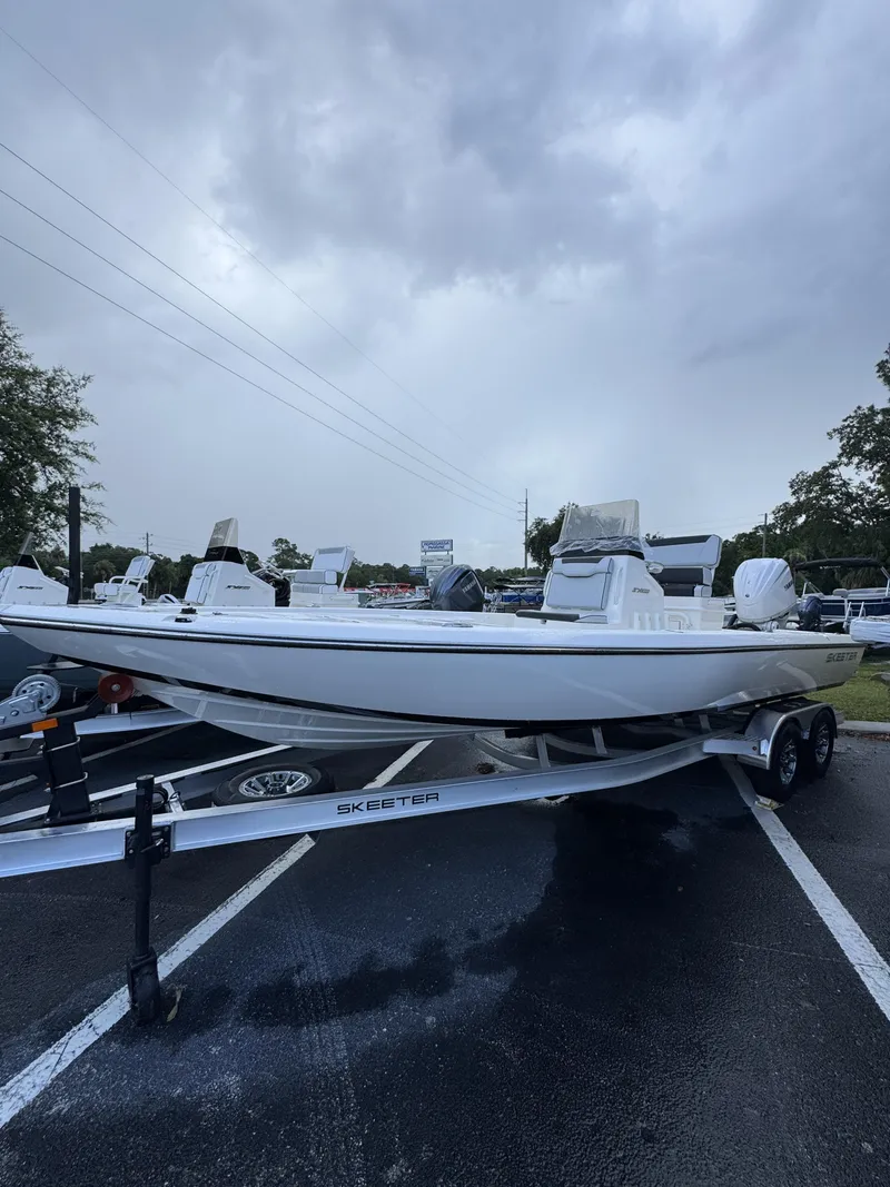 Slide: The Image of A white Skeeter SX Series SX241 boat is on a trailer in a parking lot. - 9