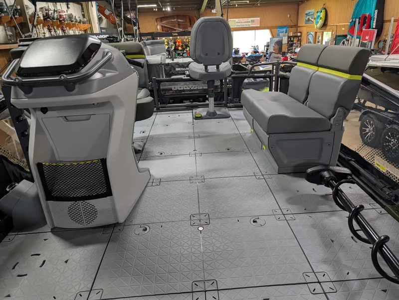 Slide: The Image of Interior of a 2026 Sea-Doo Switch Fish Compact with gray seating and a helm console. - 2