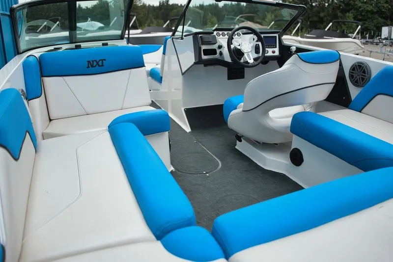 Slide: The Image of Interior view of a MasterCraft NXT20 boat with blue and white seating and a helm station. - 7