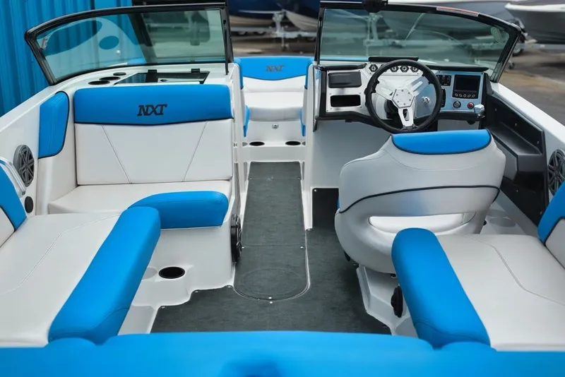 Slide: The Image of Interior of a 2016 MasterCraft NXT20 boat with blue and white seating. - 5
