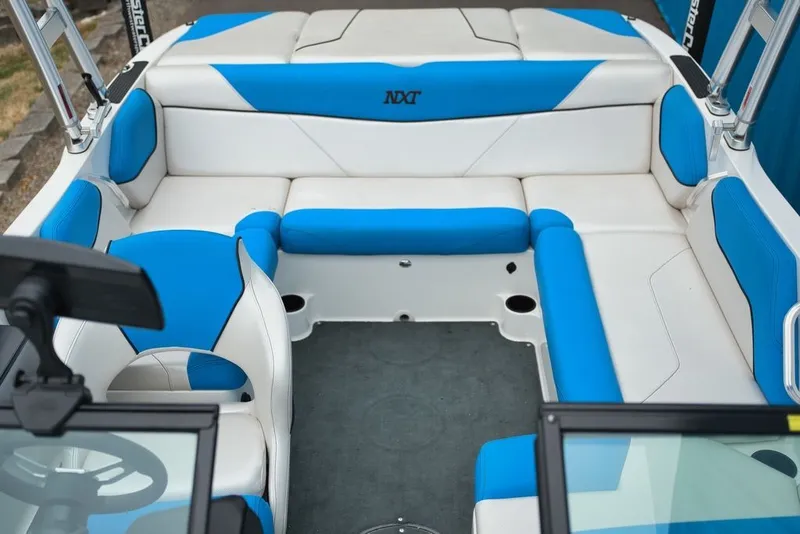 Slide: The Image of Interior of a 2016 MasterCraft NXT20 with blue and white seating. - 10