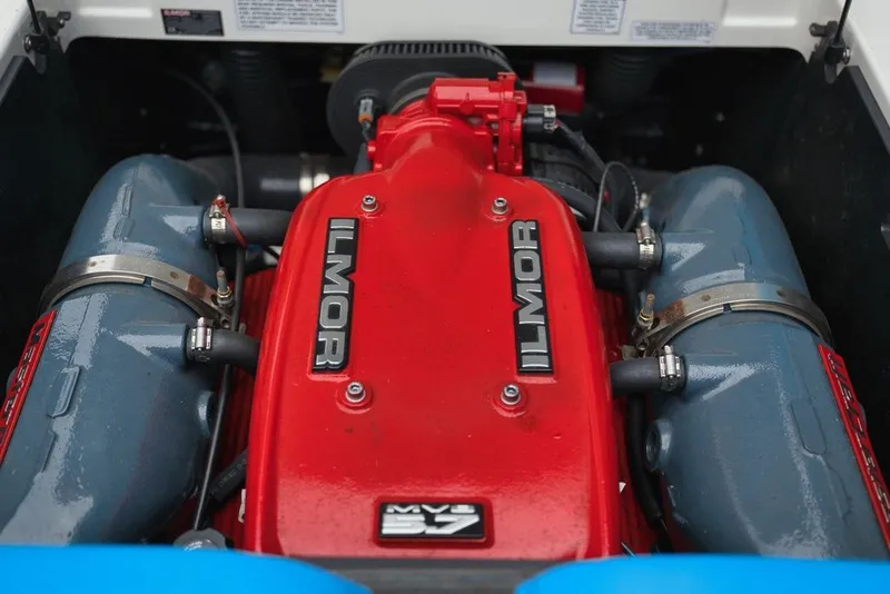 Slide: The Image of The engine compartment of a 2016 MasterCraft NXT20 features a red Ilmor engine. - 16