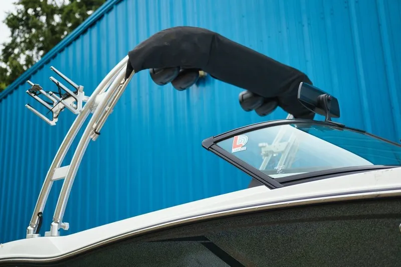 Slide: The Image of A 2016 MasterCraft NXT20 with a black bimini top against a blue background. - 15