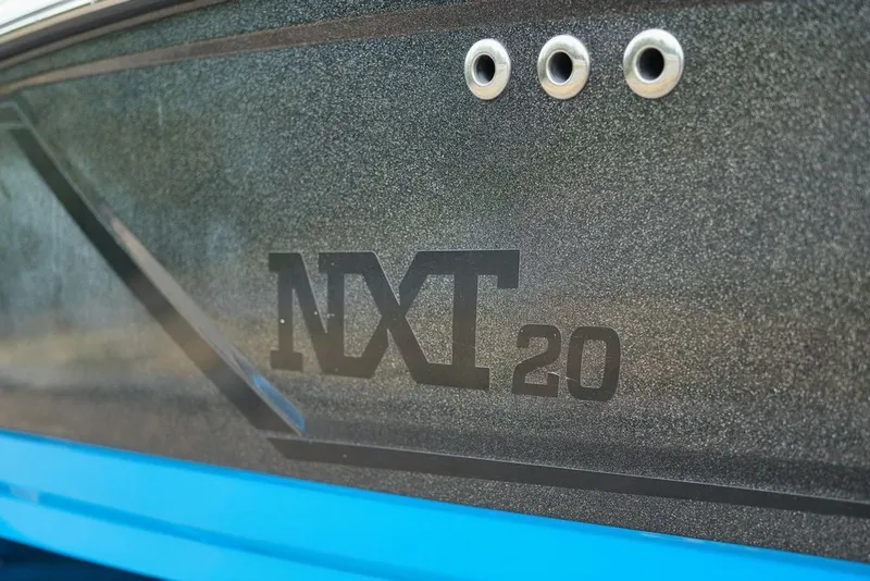 Slide: The Image of Close-up of the 2016 MasterCraft NXT20 with a glossy, textured hull. - 17