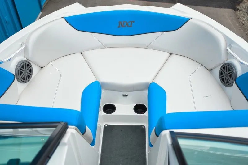 Slide: The Image of The image shows the bow area of a MasterCraft NXT20 boat with blue and white upholstery. - 8