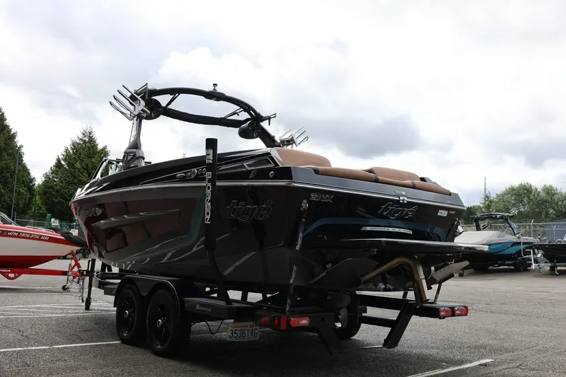 Slide: The Image of 2021 Tigé 23ZX boat on trailer, parked outdoors under cloudy sky. - 10