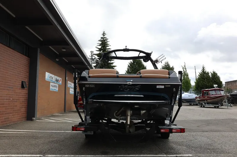 Slide: The Image of 2021 Tigé 23ZX boat on trailer, parked outside dealership with signage. - 12